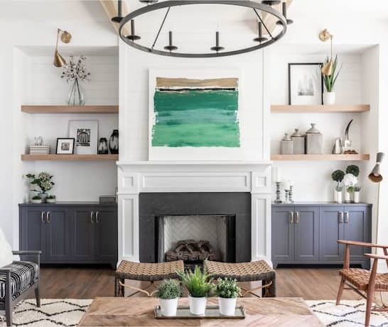 Matte black fixtures are popular in 2021. To keep your home from being dated down the line, bring in small doses of this trend and incorporate classic looks. This design by New South Home features a black chandelier and brass sconces, mixing the two finishes. (Laura Sumrak)